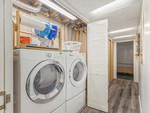 Laundry area featuring independent washer and dryer and dark hardwood / wood-style floors