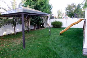 View of yard featuring a gazebo and a playground