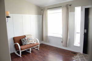 Sitting room featuring dark wood-type flooring