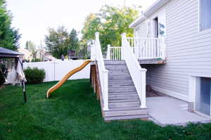 Exterior space with a yard, a gazebo, and a wooden deck