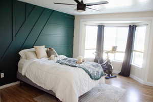 Primary Bedroom with hardwood / wood-style flooring, multiple windows, and ceiling fan