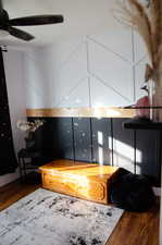 Sitting room with ceiling fan and dark hardwood / wood-style flooring