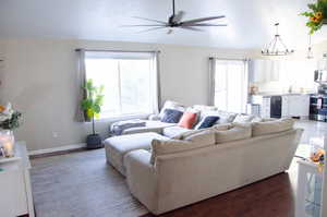 Living room with wine cooler, wood-type flooring, sink, and ceiling fan with notable chandelier