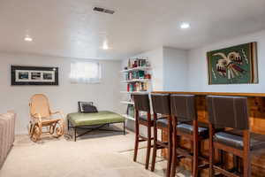 Bar featuring a textured ceiling and carpet