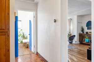 Corridor featuring a textured ceiling and light hardwood / wood-style flooring