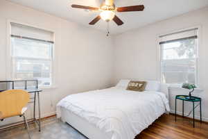 Bedroom with dark wood-type flooring and ceiling fan