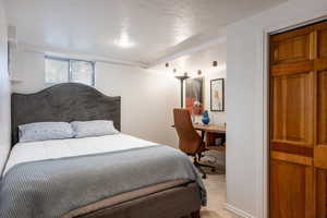 Carpeted bedroom featuring a textured ceiling