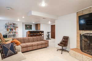 Living room with light carpet and a large fireplace