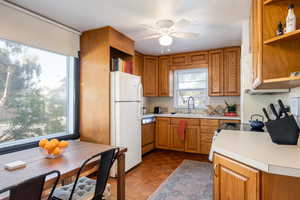 Kitchen featuring dishwasher, dark parquet floors, sink, white refrigerator, and ceiling fan