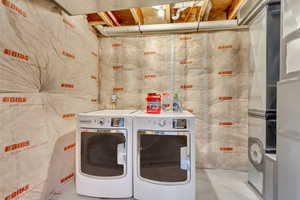 Clothes washing area featuring independent washer and dryer