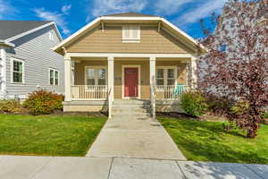 Bungalow-style house with a front yard and a porch