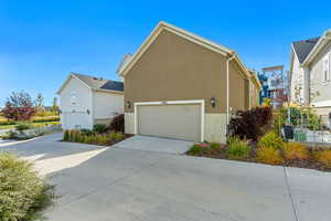 View of side of property with a garage