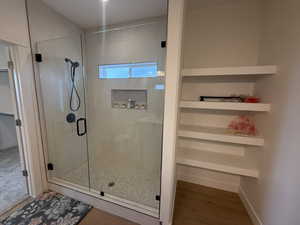 Bathroom with wood-type flooring and walk in shower