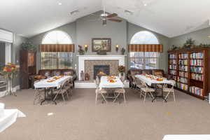 Interior space with vaulted ceiling, a wealth of natural light, and ceiling fan