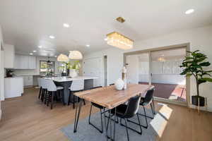 Dining space featuring a chandelier and light wood-type flooring