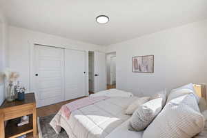 Bedroom with a closet and dark hardwood / wood-style floors