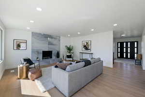 Living room featuring light hardwood / wood-style flooring and a tiled fireplace