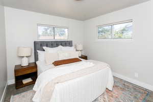 Bedroom with multiple windows and carpet floors