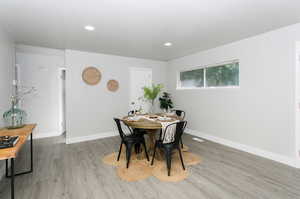 Dining space with hardwood / wood-style floors