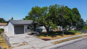 Single story home with a front lawn and a garage