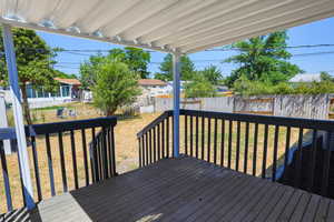 Wooden deck featuring a lawn