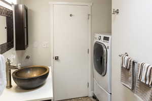 Laundry room featuring sink and washer / clothes dryer