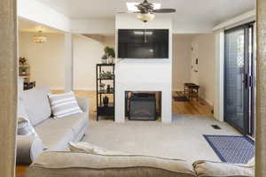 Living room with hardwood / wood-style floors and ceiling fan