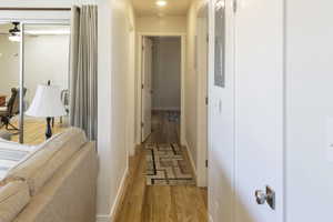 Corridor with hardwood / wood-style floors