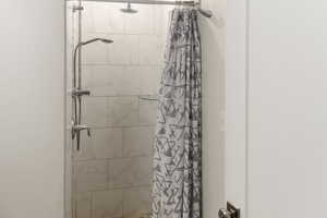 Bathroom with a shower with shower curtain