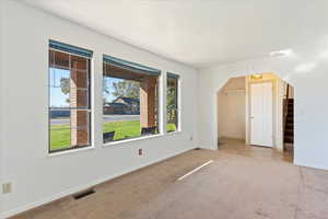 Bonus room featuring light colored carpet