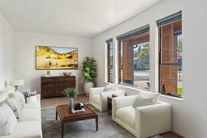 Virtually staged living room featuring wood-type flooring