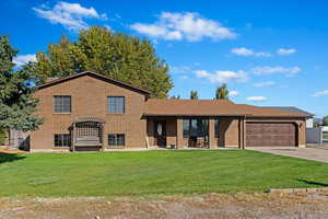 Split level home with a front yard and a garage