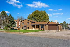 View of front of house with a front lawn and a garage