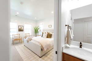 Carpeted bedroom featuring sink