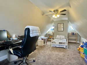 Bedroom with ceiling fan, carpet floors, and vaulted ceiling