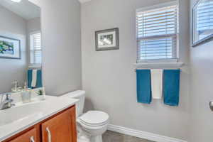 Bathroom with vanity, toilet, and tile patterned floors