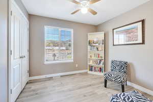 Living area featuring light hardwood / wood-style floors and ceiling fan