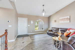 Living room with lofted ceiling and light wood-type flooring