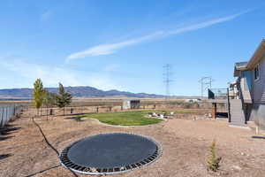 View of yard featuring a deck with mountain view and a rural view