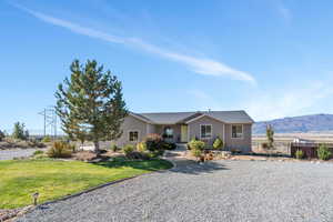 Ranch-style home with a mountain view and a front yard