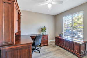 Home office featuring light hardwood / wood-style flooring and ceiling fan