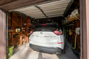 View of open garage and storage that can be added. Auto garage door and opener.