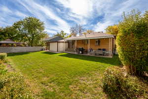 Back of house featuring a patio and a lawn. Auto-full sprinkling system is included.