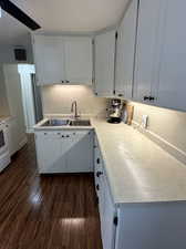 Kitchen with white cabinetry and neutral countertops.