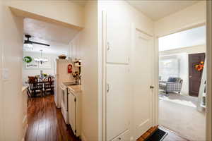 Corridor with views of the living room, kitchen and pantry.