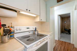 Kitchen featuring white free standing range.