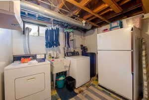 Clothes washing area featuring washer,  dryer and sink.