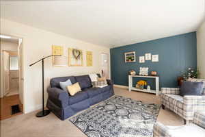 Living room with neutral colored carpet.