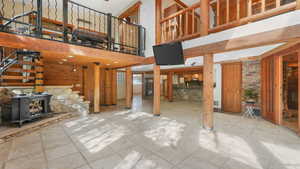 Living room featuring interior balcony and spiral staircase