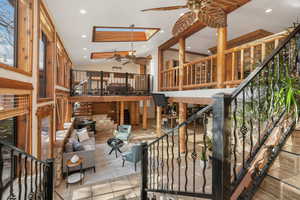 Interior space with lofted ceiling, ceiling fan, and a wealth of natural light